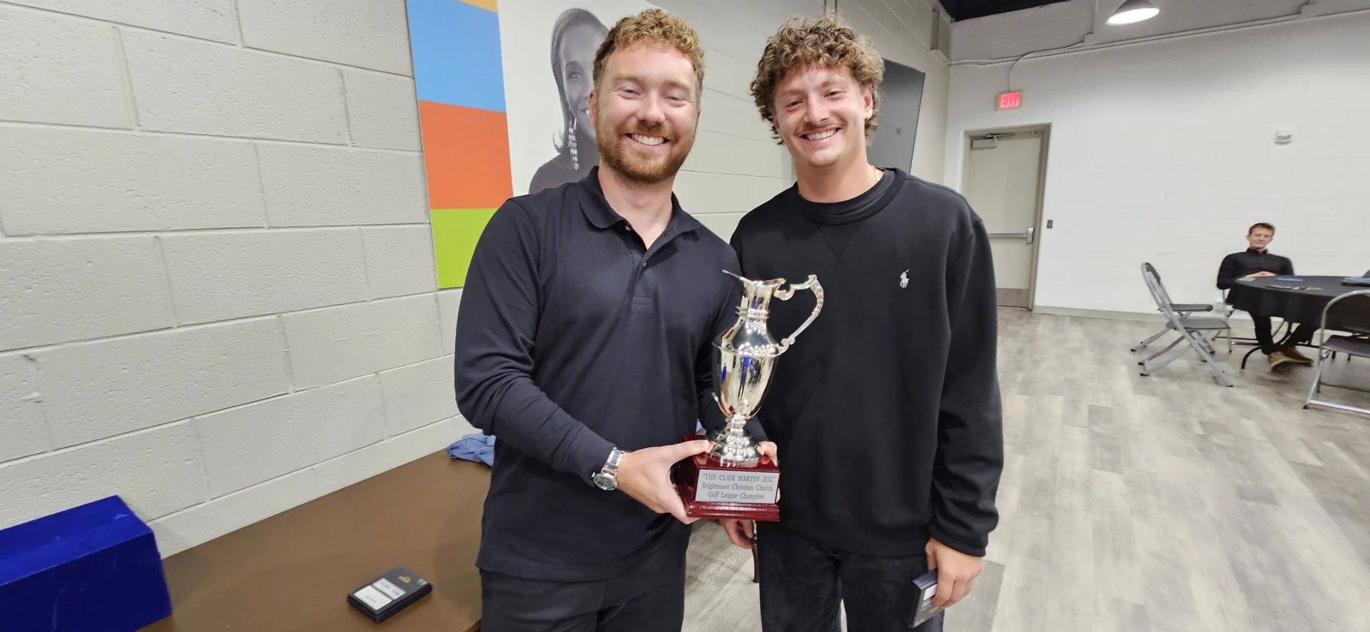 Ryan Gilliam, left, and Elijah Husereau holding the Clair Martin Jug at the 2026 league banquet